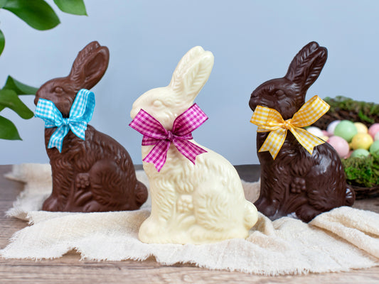 three chocolate bunnies with Easter bows around their necks