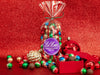 A clear bag filled with colorful chocolate balls in assorted foil colors