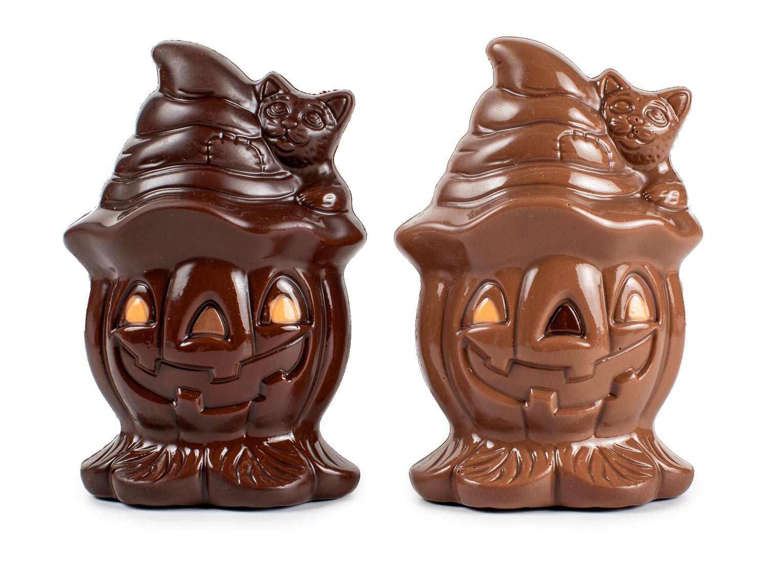 two chocolate pumpkins wearing a hat with a cat on the hat.