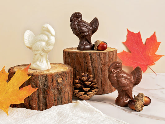 Three place setting chocolate molded turkey stands with fanned out tails.