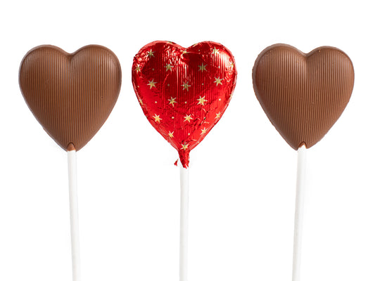 three chocolate hearts, one wrapped in a red starry foil.