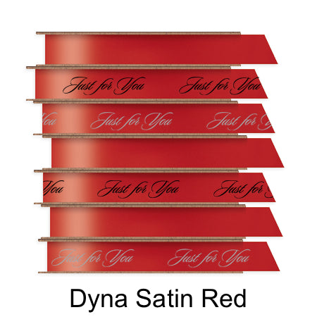 A stack of seven spools of shiny red satin ribbon with custom messages printed on them in different colors. 