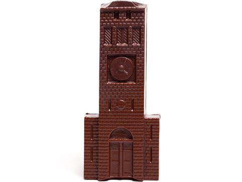 A chocolate molded brick building with a tall clock tower.